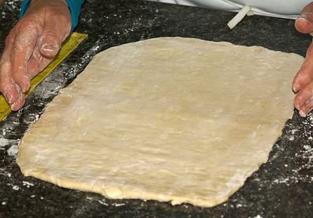 Rolling Out Croissant Dough to Cut