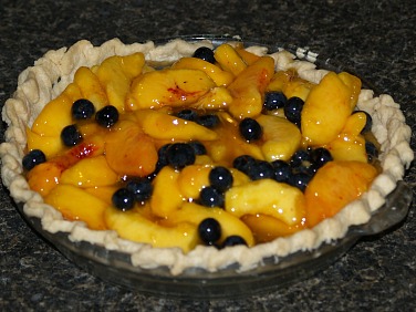 Fresh Peach and Blueberry Pie Filling in Baked Pie Crust