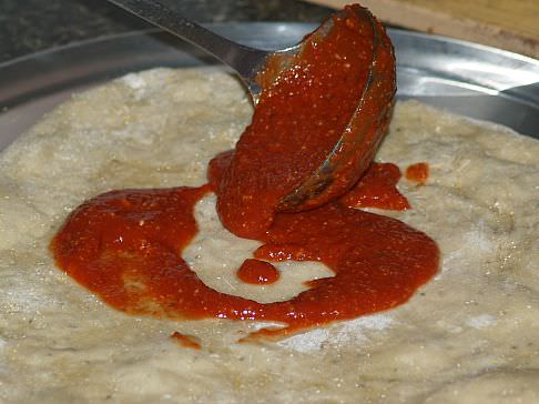 Putting Italian Pizza Sauce on Crust