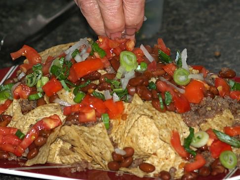 Sprinkle Green Onions Over Nachos