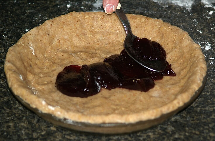 Spreading the Raspberry Jam Over the Bottom Pastry