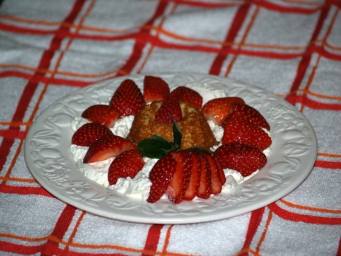moist vanilla cupcake served with strawberries and cream
