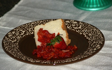 Piece of angel food cake served with strawberries