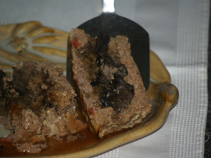 Mushroom Stuffed Meatloaf served with a Red Wine Sauce