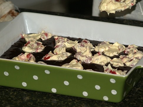 Spoon Cream Cheese and Raspberry Mixture into Batter for the Ultimate Brownies Recipe