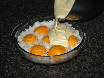 Pouring Batter Over Coconut and Peaches