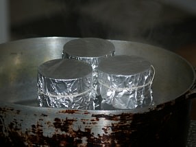 Place Tin Cans in Heavy Pan