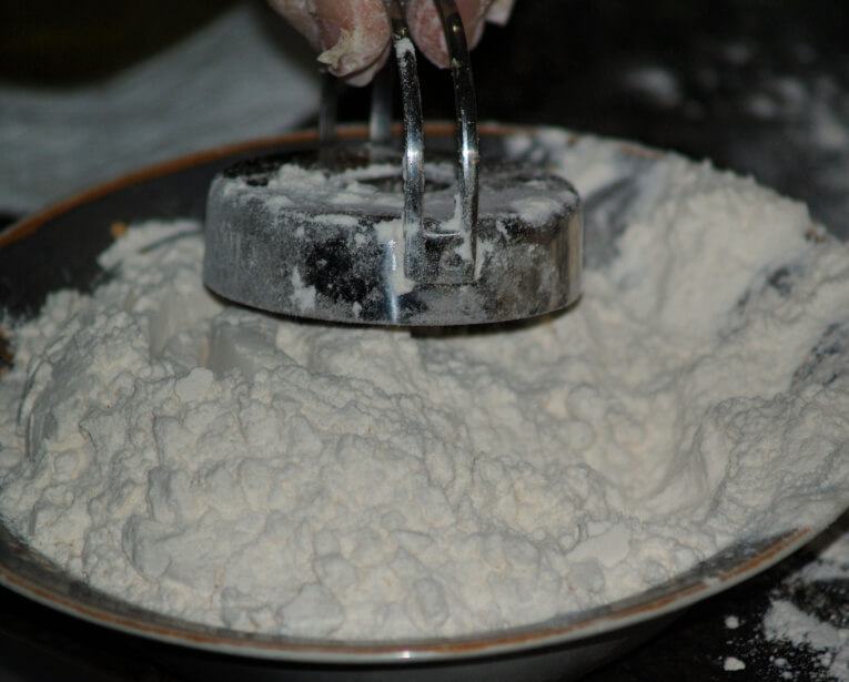 Dipping Doughnut Cutter in Flour