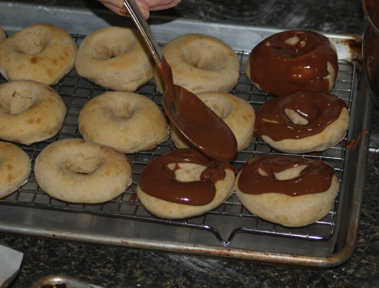 Spread Chocolate Glaze Over Doughnuts