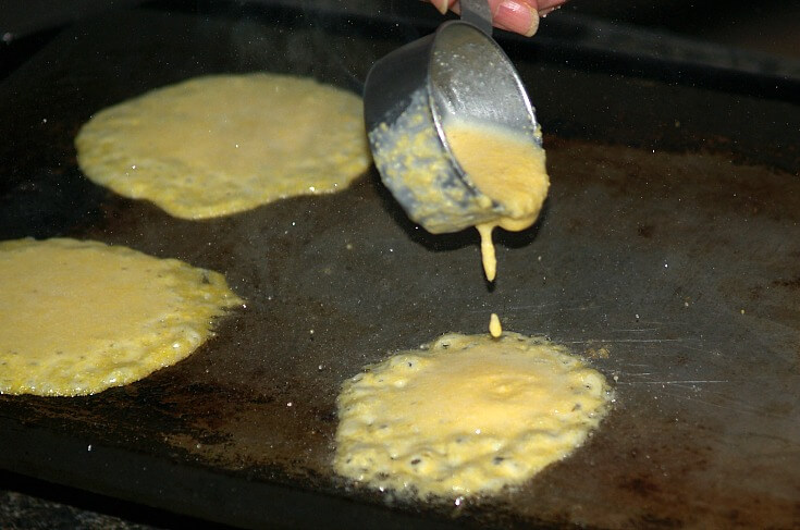 Pouring Cornmeal Pancake Batter on Griddle
